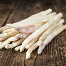 White Asparagus (selective focus) on wooden background (close-up shot)